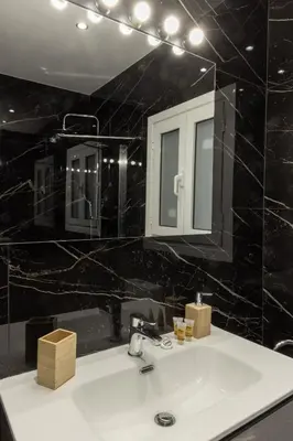 a bathroom with a sink and a mirror at Comfort Sunny Hub with 2 bdr in Athens