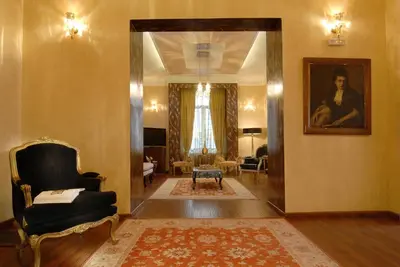 a living room with a chair and a portrait of a woman at Acropolis Museum Boutique Hotel in Athens