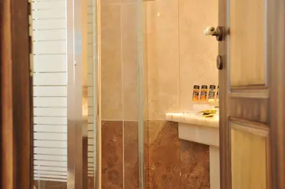 a bathroom with a shower and a sink at Acropolis Museum Boutique Hotel in Athens