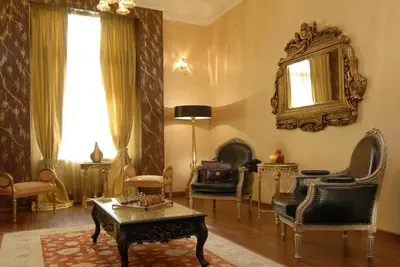 a living room with a table and chairs and a mirror at Acropolis Museum Boutique Hotel in Athens