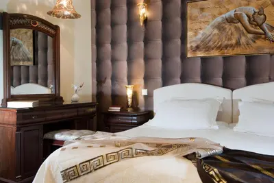 a bedroom with a large bed and a mirror at Acropolis Museum Boutique Hotel in Athens