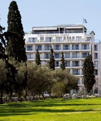 a large white building with trees in front of it at The Athens Gate Hotel in Athens