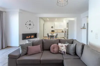 a living room with a couch and a fireplace at Athens Hill Suite in Athens