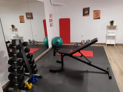 a room with a gym with a barbell and weights at Athens Hill Suite in Athens