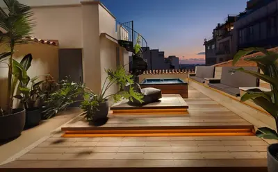 a balcony with potted plants on a building at Monument Hotel in Athens