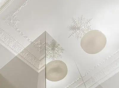 two white lights on the ceiling of a room at Monument Hotel in Athens