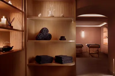 a room with shelves with towels and a table at Monument Hotel in Athens