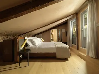 a bedroom with a bed and a large window at Monument Hotel in Athens