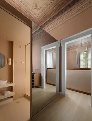 a mirror in a room with a bed and a bedroom at Monument Hotel in Athens