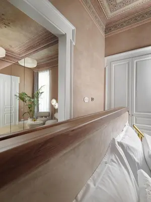 a bedroom with a large mirror and a bed at Monument Hotel in Athens