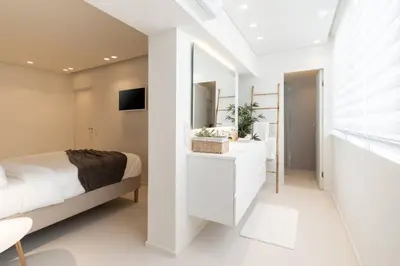 a bedroom with a white bed and a mirror at 2BD Boho Sea View Apartment by The Olon in Vari