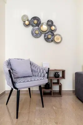 a chair in a room with plates on the wall at Koukaki Apartment in Athens