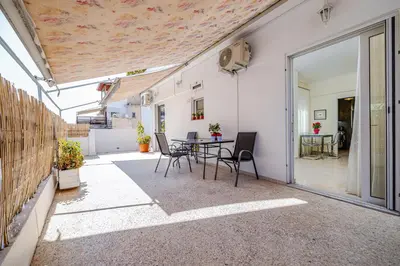 a patio with a table and chairs in a building at Koukaki Apartment in Athens