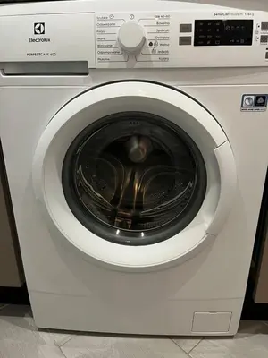 a white washing machine with its door open at Olivia Luxury Apartment Palio Faliro in Athens