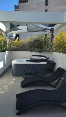 a patio with a table and chairs and a bench at Koniama Acropolis in Athens