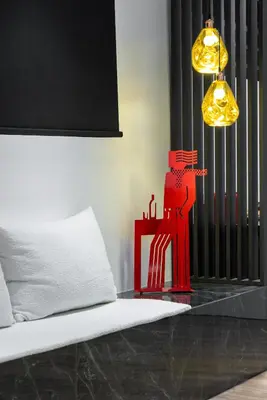 a room with a bed with a red object and a lamp at Koniama Acropolis in Athens