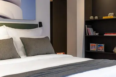 a bedroom with a bed and a book shelf at Koniama Acropolis in Athens
