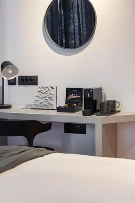 a bedroom with a desk with a bed and a mirror at Koniama Acropolis in Athens