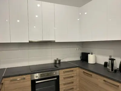 a kitchen with white cabinets and a stove top oven at ATHENS SEA VIEW GUEST HOUSE in Athens