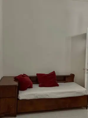 a bed with two red pillows on top of it at Feels like home (Vari) in Vari