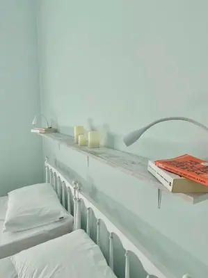 a shelf with two pillows and a book on it at Feels like home (Vari) in Vari