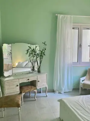 a bedroom with a desk with a mirror and a bed at Feels like home (Vari) in Vari