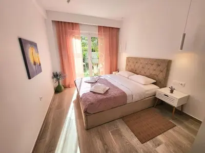 a bedroom with a large bed and a window at Nice Apartment Near Flisvos VIPGreece in Athens