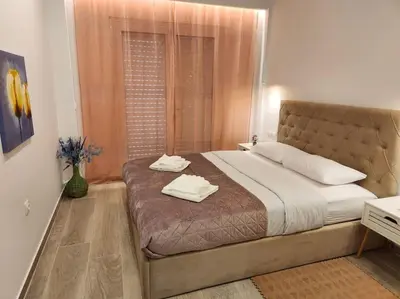 a bedroom with a large bed with two towels on it at Nice Apartment Near Flisvos VIPGreece in Athens
