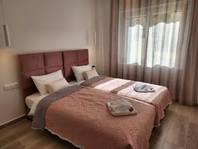 a bedroom with a large bed and a window at Nice Apartment Near Flisvos VIPGreece in Athens