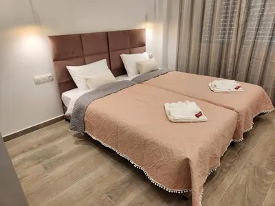 a bedroom with a large bed with two towels on it at Nice Apartment Near Flisvos VIPGreece in Athens