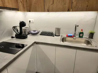 a kitchen counter top with a sink and a counter top at Nice Apartment Near Flisvos VIPGreece in Athens