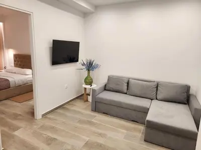 a living room with a couch and a bed at Nice Apartment Near Flisvos VIPGreece in Athens