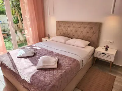 a bedroom with a large bed with two towels on it at Nice Apartment Near Flisvos VIPGreece in Athens