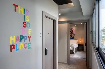 a room with a happy place sign on the door at Psiri Vibes in Athens