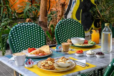 a table with plates of food and cups of coffee at Psiri Vibes in Athens
