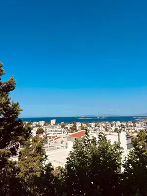 a view of a city with the ocean in the background at Sea View House Voula in Athens