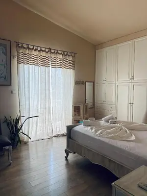 a bedroom with a bed and a large window at Sea View House Voula in Athens