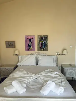 a bedroom with a bed with towels on it at Sea View House Voula in Athens
