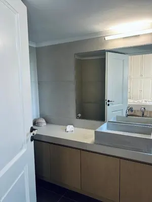 a bathroom with a sink and a large mirror at Sea View House Voula in Athens