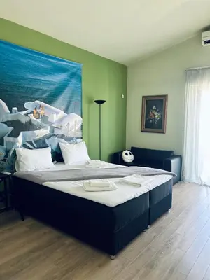 a bedroom with a large bed in a room at Sea View House Voula in Athens