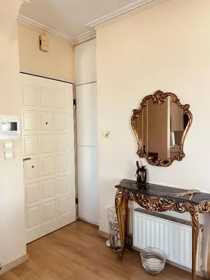 a mirror on a wall next to a door at Sea View House Voula in Athens