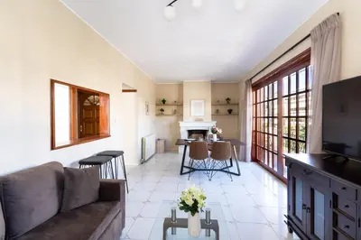 a living room with a couch and a table at AIOLOS LUXURY alimos center Suite II near the sea in Athens