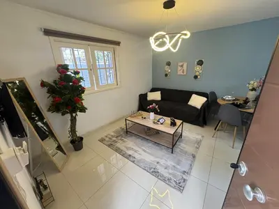 a living room with a couch and a table at AIOLOS COZY alimos center APARTMENT near the sea in Athens
