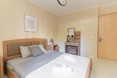 a bedroom with a bed with two towels on it at AIOLOS COZY alimos center APARTMENT near the sea in Athens