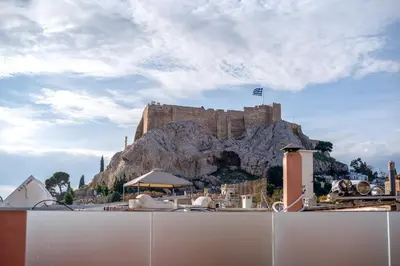 a castle on top of a mountain with a fence at Farmaki Residence, Plaka in Athens