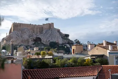 a castle on top of a mountain with buildings at Farmaki Residence, Plaka in Athens