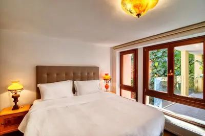 a bedroom with a large bed and a window at Farmaki Residence, Plaka in Athens