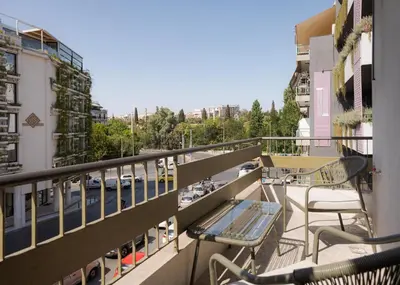 a balcony with chairs and a view of a street at Olympian Zeus Residences in Athens