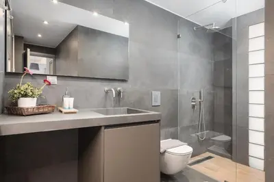 a bathroom with a sink and a toilet and a shower at Olympian Zeus Residences in Athens