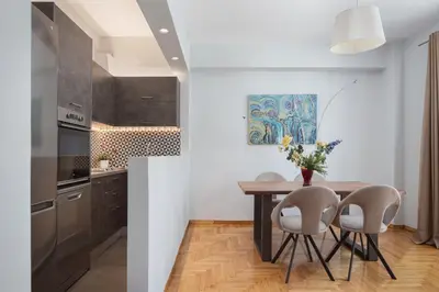 a kitchen with a dining room table and chairs at Olympian Zeus Residences in Athens